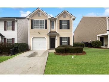 Charming two-story home with a well-maintained front yard and a one car garage at 180 Fieldview Ln, Covington, GA 30016