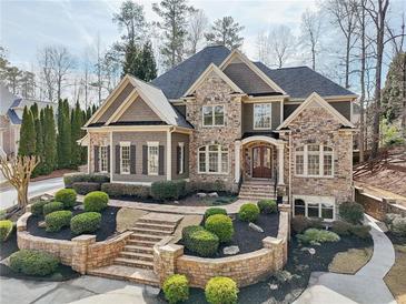 Beautiful stone and shake home with professional landscaping and front entry stair case at 11180 West Rd, Roswell, GA 30075