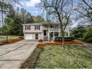 Charming split-level home with front porch and a well-maintained front yard at 3783 Red Rose Ct, Loganville, GA 30052