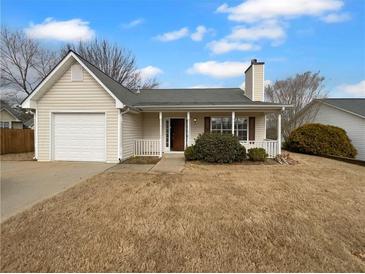 Charming single-story home with a cozy front porch and attached garage at 328 Village Ln, Stockbridge, GA 30281