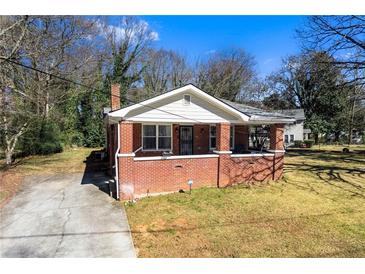 Charming brick home featuring a cozy front porch and well-maintained yard, perfect for suburban living at 2163 Ben Hill Rd, Atlanta, GA 30344