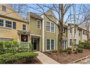 Charming townhouse featuring a well-maintained exterior and inviting front walkway to the covered front porch at 5065 Avalon Dr, Alpharetta, GA 30005