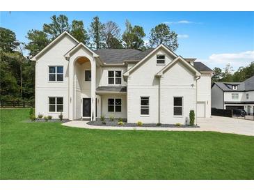 Charming two-story home featuring a manicured lawn, brick facade, and a welcoming arched entryway at 4332 Kay Morgan Rd, Buford, GA 30519