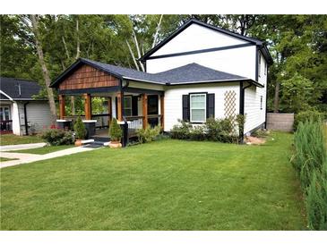 Charming two-story home featuring a well-manicured lawn and inviting front porch at 657 S Grand Nw Ave, Atlanta, GA 30318