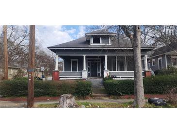 Charming two-story home with a screened-in porch and landscaped front yard at 540 Langhorn Sw St, Atlanta, GA 30310