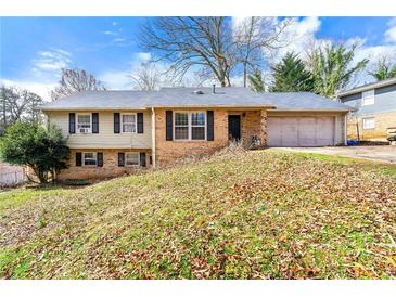 Charming split-level home with a brick and siding exterior and an attached two-car garage at 2671 Lee Ann Dr, Marietta, GA 30066