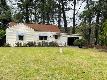 Charming single-Gathering home with a spacious front yard and attached garage at 1821 Lomita Se Rd, Atlanta, GA 30316