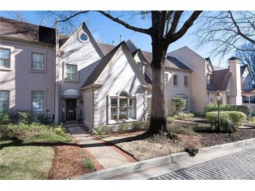 Charming traditional townhome featuring a manicured lawn and beautiful architectural details at 2525 Peachtree Ne Rd # 25, Atlanta, GA 30305