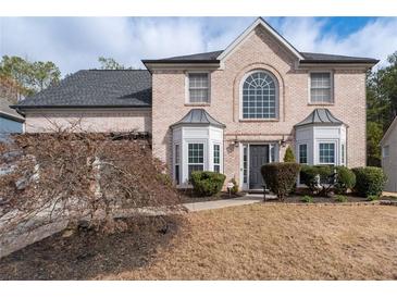 Charming brick home features a well-manicured lawn and classic architectural details at 2971 Montview Sw Dr, Marietta, GA 30060
