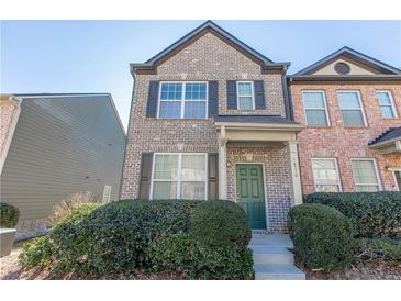Charming two-story brick townhome features well-maintained landscaping and a welcoming front entrance at 1830 Bayrose Cir # 30B, East Point, GA 30344