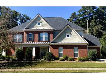 Charming two-story brick home with a well-manicured lawn and attractive landscaping at 3162 Abbey Sw Dr, Atlanta, GA 30331