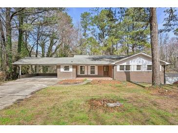 Charming brick home featuring a covered carport and a well-maintained front yard at 3339 Brenda Ln, Lithia Springs, GA 30122