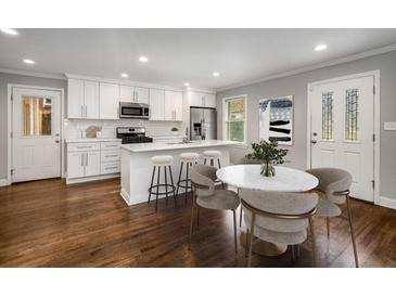 Bright kitchen features a center island, stainless steel appliances, and hardwood floors at 2026 Swazey Dr, Decatur, GA 30032