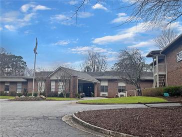 Well-maintained single-story brick building with manicured lawns and a convenient covered entrance for easy access at 475 Mount Vernon Ne Hwy # C230, Sandy Springs, GA 30328
