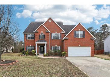 Beautiful two-story brick home featuring a well-manicured lawn and attached two-car garage at 114 Highgrove Pl, Mcdonough, GA 30253