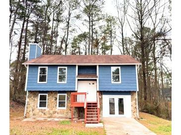 Charming two-story home boasts a combination stone and siding exterior and inviting entry steps at 782 Fox Valley Dr, Stone Mountain, GA 30088