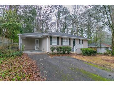 Charming single-story home with brick facade, black shutters, and a covered carport at 2024 Rosewood Rd, Decatur, GA 30032