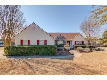 Charming single-story home featuring manicured landscaping and red shutters at 1553 Nicole Ridge Ct, Loganville, GA 30052