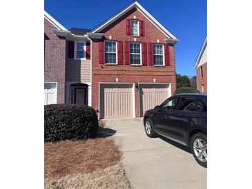 Charming two-story brick home with a two-car garage and well-maintained landscaping at 2610 Gadsen Walk, Duluth, GA 30097