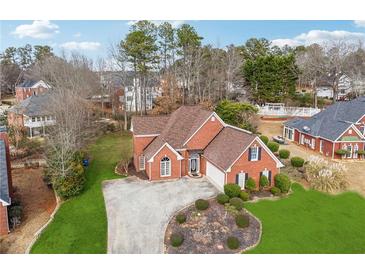 Charming brick home featuring a well-manicured lawn and a welcoming front entrance at 3207 Haleys Way, Conyers, GA 30013
