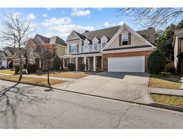 Charming two-story home with a manicured lawn and attached two-car garage at 1481 Wild Rye Ln, Grayson, GA 30017