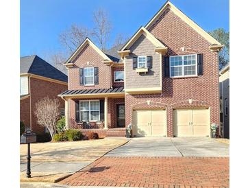 Two-story brick home with a two-car garage and manicured front lawn, exuding classic curb appeal at 2571 Royston Dr, Duluth, GA 30097