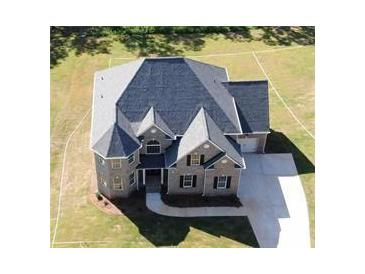 An aerial view showcases this two story house and its yard at 8013 White Stone Blvd, Douglasville, GA 30135