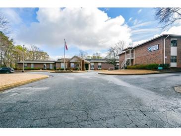 A welcoming exterior view of the Mount Vernon Village community building and main entrance at 475 Mount Vernon Ne Hwy # A-102, Sandy Springs, GA 30328