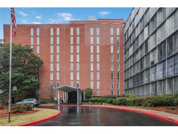 Brick building exterior with covered entrance, US flag, driveway and some green landscaping at 3060 Pharr Court North Nw # 619, Atlanta, GA 30305