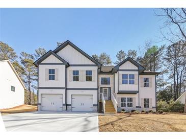 New construction two-story home featuring a two-car garage and professionally landscaped front yard at 3278 Greenhill Dr, Villa Rica, GA 30180
