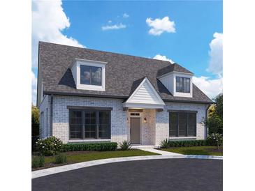 Charming exterior view of a brick home featuring a gray roof and manicured landscaping at 106 Cottage Gate Ln, Roswell, GA 30076
