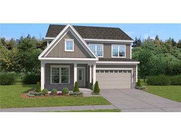 Two-story home featuring gray siding, a two-car garage and professionally landscaped yard at 428 Madison Lakeview Dr, Acworth, GA 30102