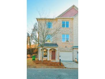 Charming two-story home with a brick facade and well-manicured front yard at 4879 Pinnacle Dr, Stone Mountain, GA 30088