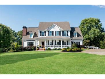 Traditional two-story home with a lush lawn and a welcoming front porch with black shutters and columns at 1525 Thomas Rd, Canton, GA 30115