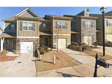 Attractive townhome exterior boasts stone accents, individual driveways, and inviting curb appeal at 266 Valley Xing, Canton, GA 30114