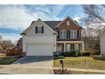 Charming two-story home with a manicured lawn, lovely landscaping, and a two car garage at 301 Ridgewood Trl, Canton, GA 30115