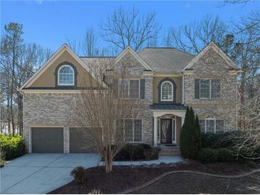 Charming two-story brick home featuring a two-car garage and manicured landscaping at 7290 Weber St, Atlanta, GA 30349