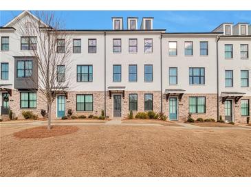 Modern townhome featuring painted brick, black-framed windows and inviting entryway at 1115 Larkin Dr, Buford, GA 30518