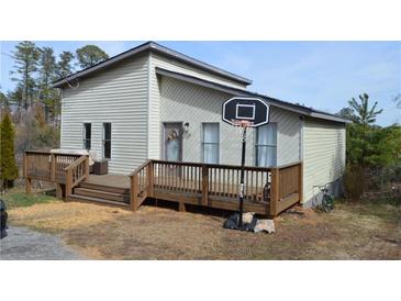 Charming home with a large wooden deck and a basketball hoop, perfect for outdoor fun at 2100 Driftwood Cir, Cumming, GA 30041