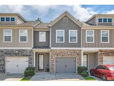 Charming townhome with stone accents, gray siding, and a two-car garage at 5036 Longview Walk, Decatur, GA 30035