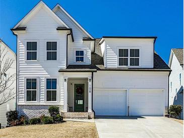 Charming two-story home with a two car garage and a welcoming green front door at 108 Fieldbrook Xing, Holly Springs, GA 30115