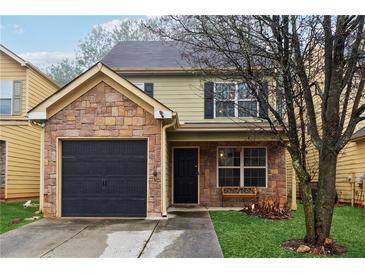 Charming two-story home with stone accents and a well-maintained front yard at 1042 Wedgewood Ct, Conyers, GA 30012