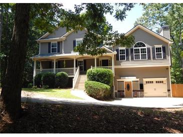 Charming two-story home featuring a welcoming front porch and a well-maintained landscaped yard at 132 Hammond Dr, Canton, GA 30114