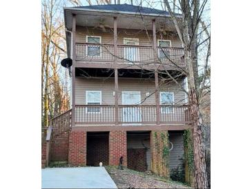 Charming multi-level exterior featuring a spacious porch on each level and sturdy brick foundation at 1470 Andrews Nw St, Atlanta, GA 30314