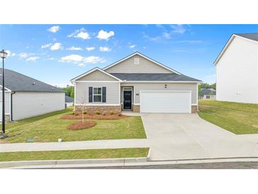 Charming single-Gathering home boasts a well-manicured lawn, attached garage, and inviting front entrance at 8603 Secretariat Dr, Lithonia, GA 30058