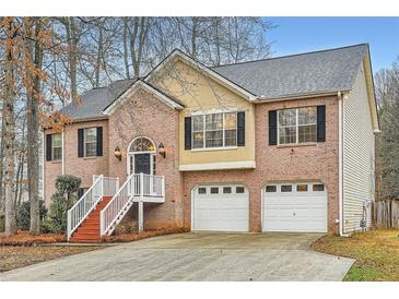 Charming two-story brick home with a well-maintained lawn and attached two-car garage at 4030 Staghorn Ct, Douglasville, GA 30135