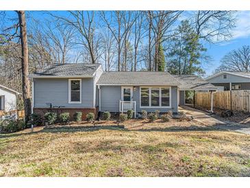 Charming home with gray siding, tidy landscaping, and a convenient covered carport at 4981 Crowe Se Dr, Smyrna, GA 30082