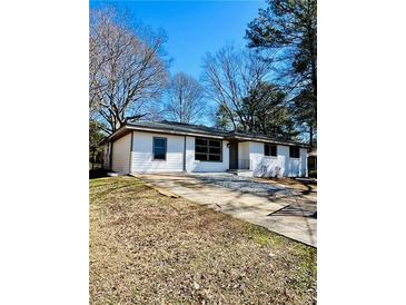 Inviting home with a well-maintained lawn, fresh white paint, and a classic design at 2213 Sandtown Sw Rd, Marietta, GA 30060