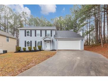 Charming two-story home with blue siding, black shutters, and well-maintained landscaping at 5724 Antelope Trl, Atlanta, GA 30349