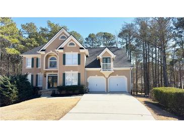 Charming two-story home boasts a manicured lawn and a two-car garage at 4569 Campenille Trce, Suwanee, GA 30024